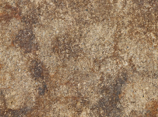 close up of the surface of a brown and rust coloured rock