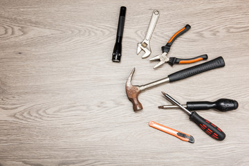 The repair tools is placed on the wooden table.