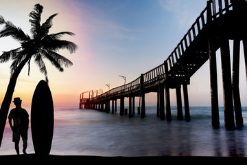 silhouette man and wood bridge