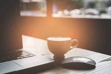 Coffee cup and laptop for business.