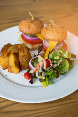 Delicious hamburgers served on wooden planks
