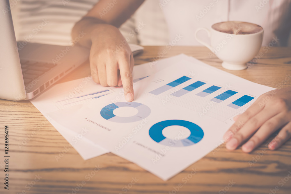 Poster image of hand pointing on a graph data