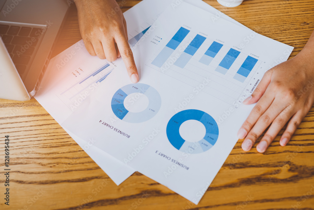 Poster image of hand pointing on a graph data