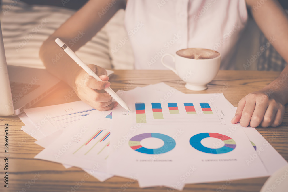 Poster Image of hand pointing on a graph data