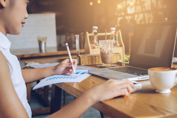 Businesswoman checking paper, chart or business report on a work