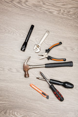 The repair tools is placed on the wooden table.