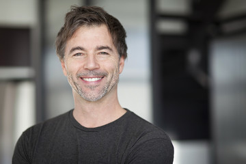 Portrait Of A Mature Man Smiling At The Camera. Home