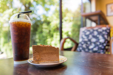 Fototapeta na wymiar Ice coffee and chocolate mousse on wood table,american Coffee,Am