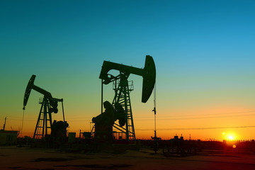The beam pumping unit is homework, sunset in oil field