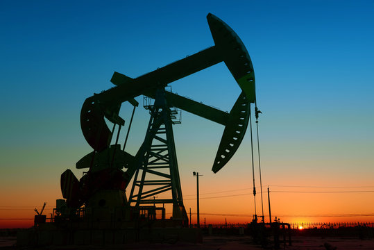 The beam pumping unit is homework, sunset in oil field