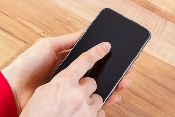 Hand of woman touching blank screen of mobile phone