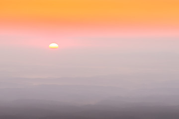 A dream like smoky sunrise in the Blue Ridge Mountains as the smoke from the recent forest fires mixes with condensation that is settled in the valleys below the Linville Gorge Wilderness Area