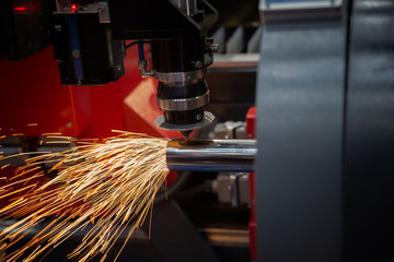 Cutting of sheet metal. Sparks fly from laser by automatic cutti