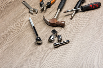 The repair tools is placed on the wooden table.