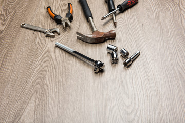 The repair tools is placed on the wooden table.