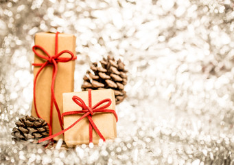 Christmas background with decorative gift and pine cones.