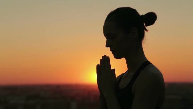 Two shots. Sporty woman practicing yoga in the park at sunset - making hand greeting namaste, drop back and wheel pose. Sunset light, golden hour, lens flares. Freedom, health and yoga concept