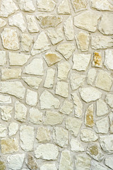 Yellow wall with stone masonry, background, texture