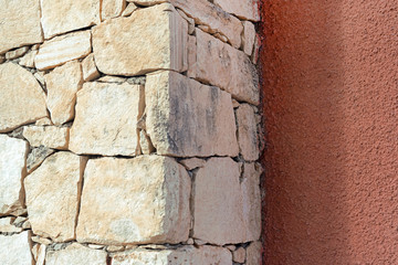 Angle of the wall with stone masonry, background