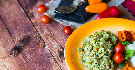 Risotto with vegetables, on wooden  background
