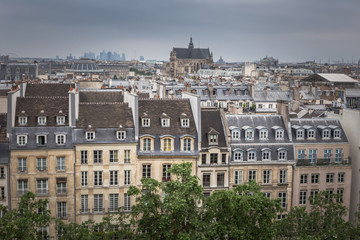 Fototapeta na wymiar Paris aerial cityscape view of historical apartment buildings and Paroisse Saint-Eustache cathedral or the Church of Saint Eustache. View from the top of The Centre Pompidou modern art museum.