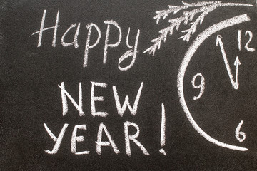 Happy new year 2017, hand writing with chalk on blackboard.