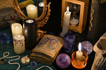 Fototapeta na wymiar Magic still life with the Tarot cards, mirrow and burning candles