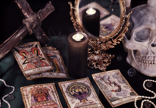 Vintage still life with the Tarot cards, mirrow and skull