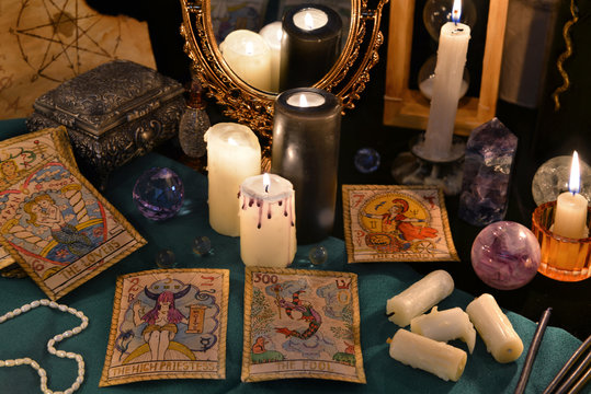 Magic still life with crystals, the Tarot cards and candles by the mirrow