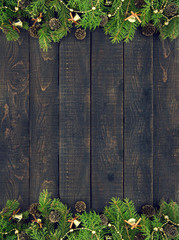 Frame from decorated Christmas tree on rustic wooden background