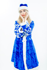 The Snow Maiden in blue Christmas costume. Beautiful white girl with long blond hair. Facial makeup and blue nails. Isolated on white background.