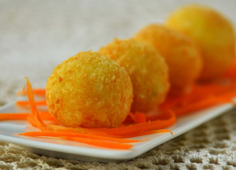 potato cheese ball on a white plate