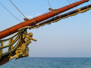 Bowsprit of the ancient sailing ship on the blue sky background