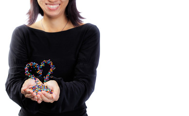 woman holding colorful plastic polymer granules