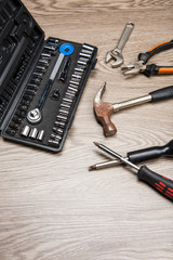 The repair tools is placed on the wooden table.