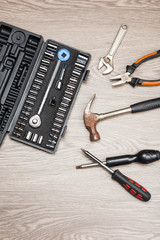 The repair tools is placed on the wooden table.