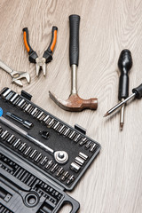 The repair tools is placed on the wooden table.