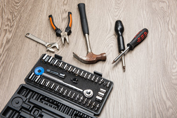 The repair tools is placed on the wooden table.