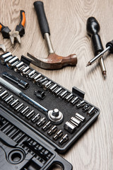 The repair tools is placed on the wooden table.