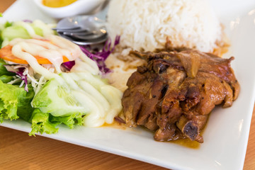 Roasted chicken with rice and vegetable salad.