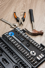 The repair tools is placed on the wooden table.
