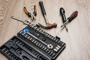 The repair tools is placed on the wooden table.