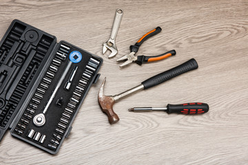 The repair tools is placed on the wooden table.