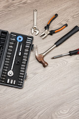 The repair tools is placed on the wooden table.