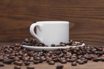 Black coffee in white mug and grains