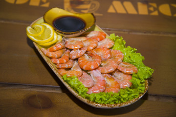 Mouth-watering shrimp on a plate lined with lettuce.