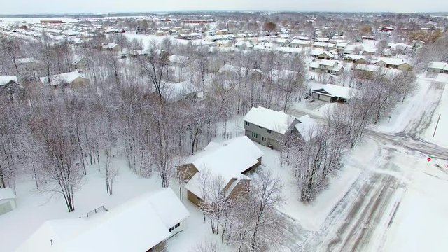 Small town neighborhood under a fresh, deep blizzard snowfall.
