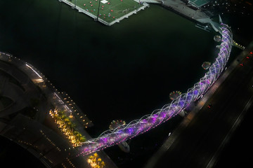 Singapore, Republic of Singapore - August 10, 2016:Bird Eye View of Helix Bridge Cross The River at Night.purple bridge.Top View Bridge. selective focus and low light back ground