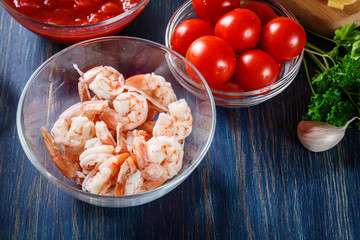 Ingredients ready for preparing pappardelle pasta with shrimp, tomatoes and herbs