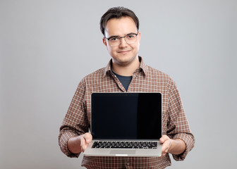 Man holding and showing laptop computer